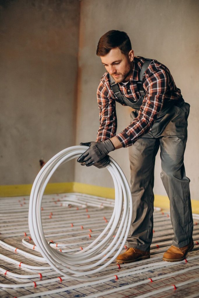 Plumber guy is installing pipes